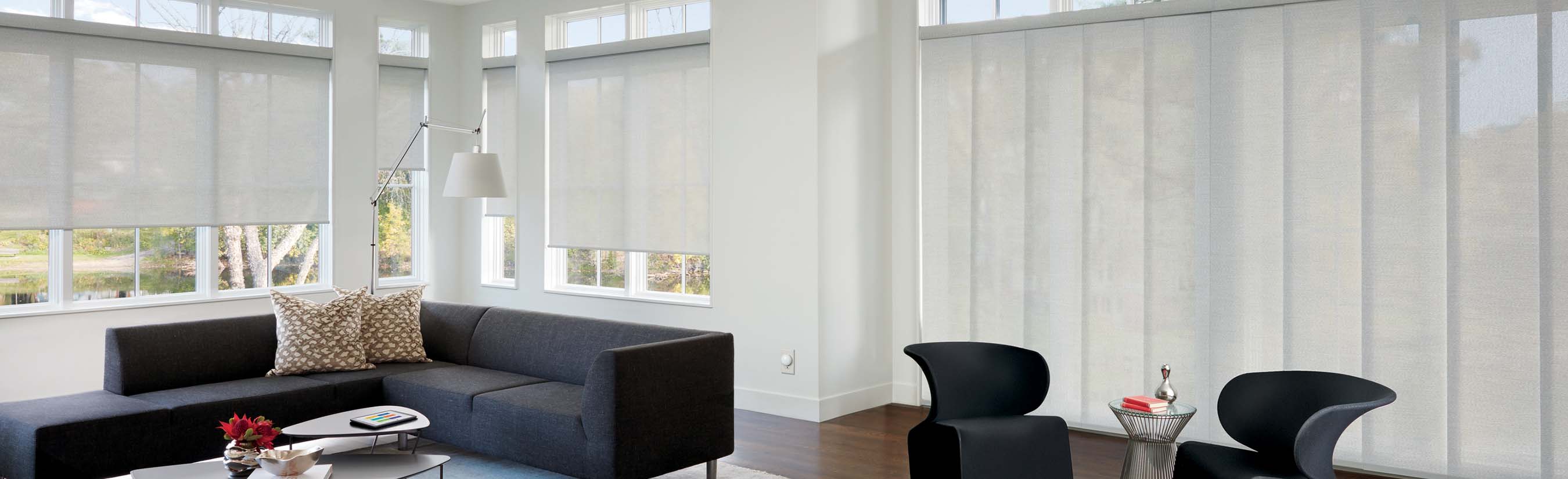 White roller shades in a modern living room.